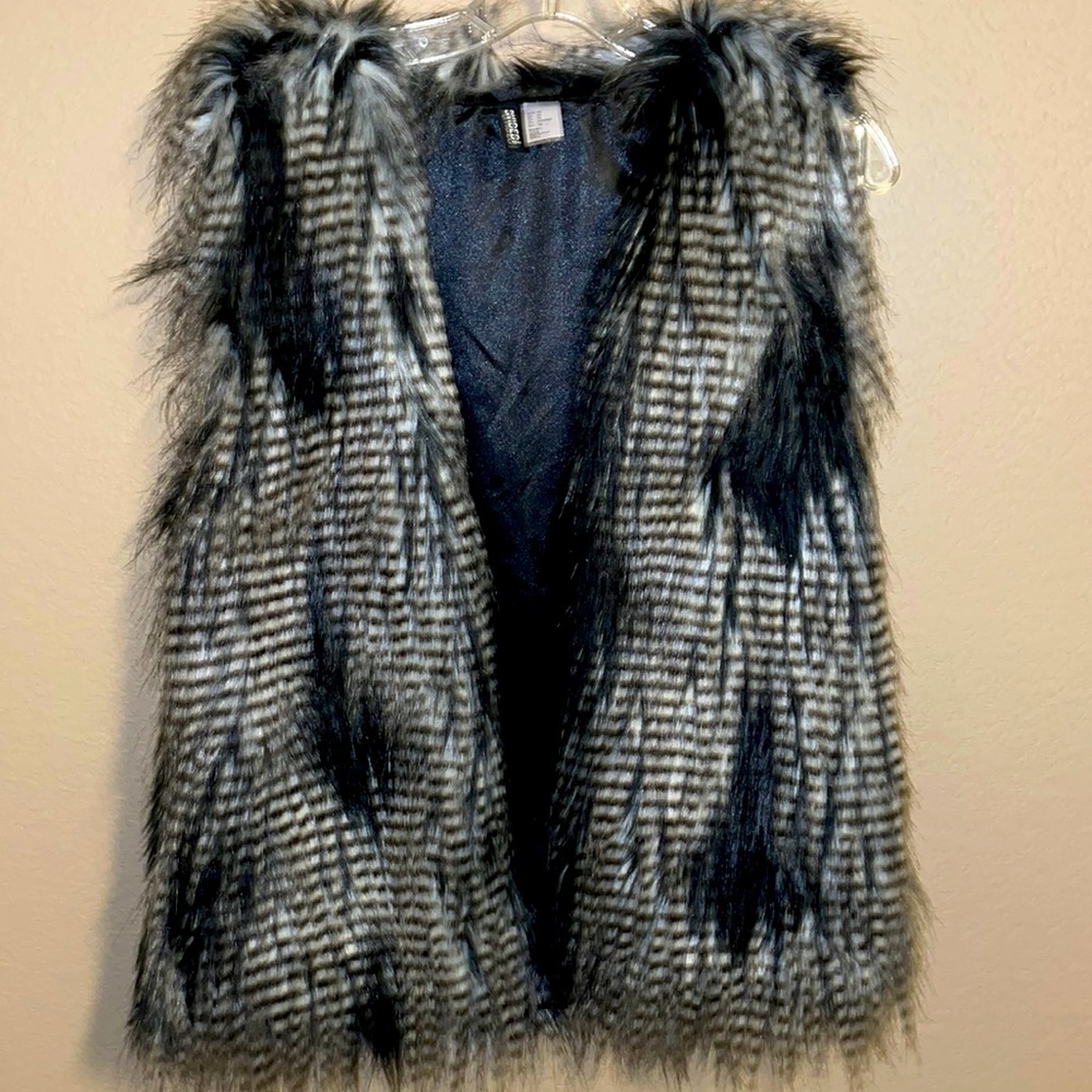 A faux fur vest, black white and gray, size 10 only been worn once.